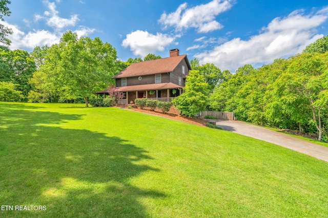 6605 Lammie Branch Ln, Knoxville, TN 37938 - back of house with a chimney, brick siding, concrete driveway, and covered porch