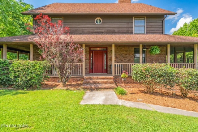 6605 Lammie Branch Ln, Knoxville, TN 37938 - farmhouse-style home with a chimney, a front lawn, a porch, brick siding, and roof with shingles