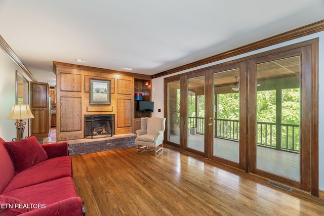 6605 Lammie Branch Ln, Knoxville, TN 37938 - living area with a brick fireplace, ornamental molding, plenty of natural light, french doors, and wood finished floors