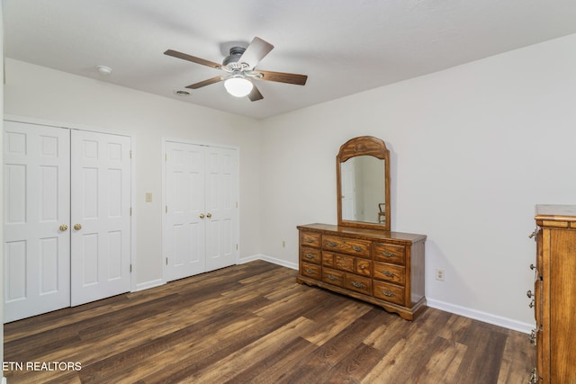 6605 Lammie Branch Ln, Knoxville, TN 37938 - unfurnished bedroom with two closets, wood finished floors, baseboards, and a ceiling fan