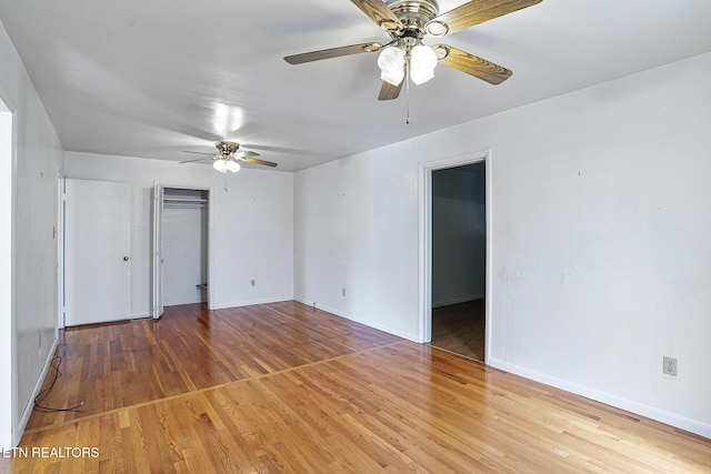 spare room featuring a ceiling fan, wood finished floors, and baseboards