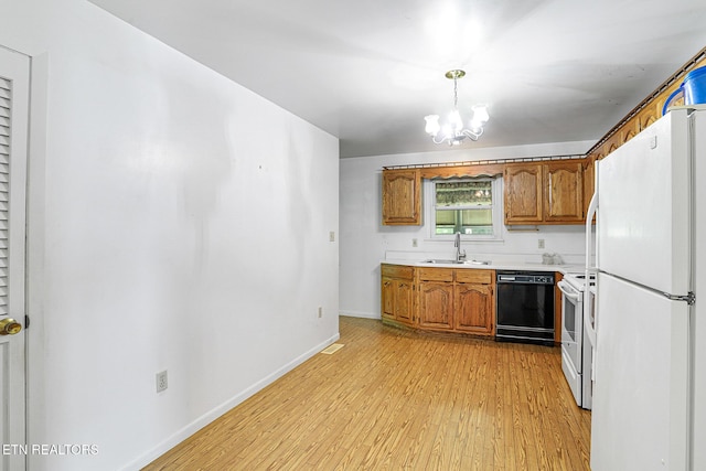 kitchen with white appliances, a sink, brown cabinets, light wood-type flooring, and baseboards