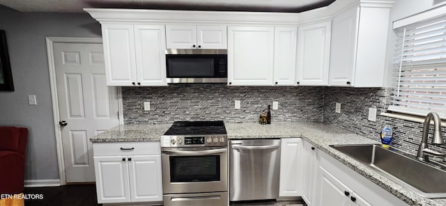 4808 Beverly Field Way, Knoxville, TN 37918 - kitchen with stainless steel appliances, a sink, backsplash, white cabinets, and baseboards