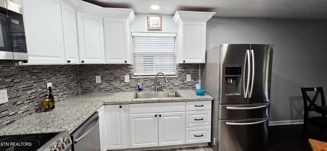 4808 Beverly Field Way, Knoxville, TN 37918 - kitchen with stainless steel appliances, a sink, tasteful backsplash, white cabinets, and light stone countertops