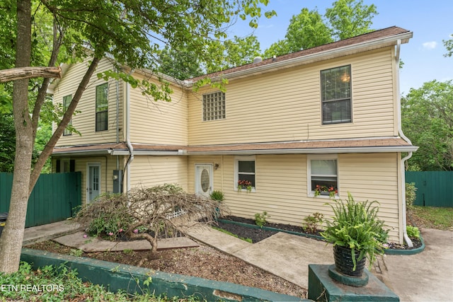 view of front of home with fence and a patio area