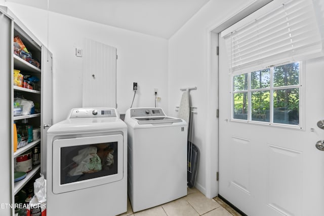 washroom featuring washer and dryer and light tile patterned floors
