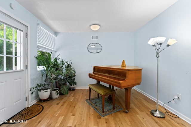 sitting room featuring light wood-style flooring and baseboards