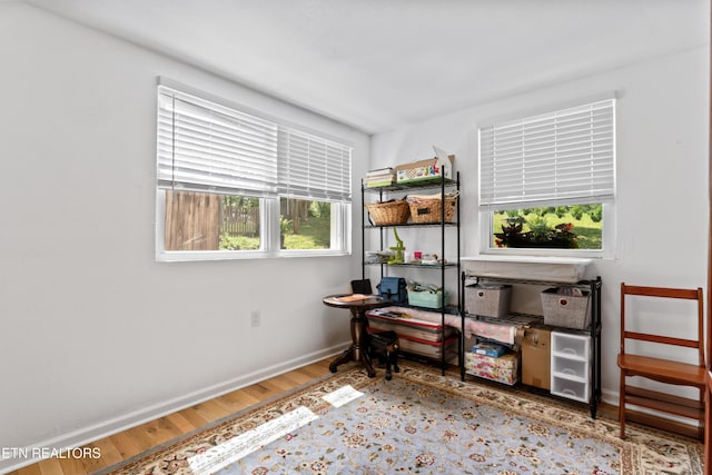 bedroom with wood finished floors and baseboards