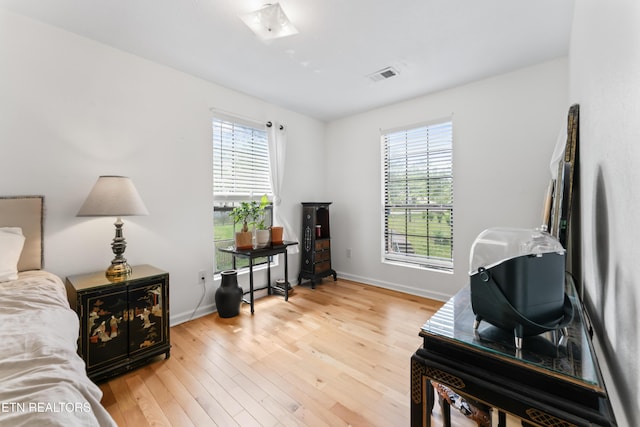 bedroom with light wood-style floors and baseboards
