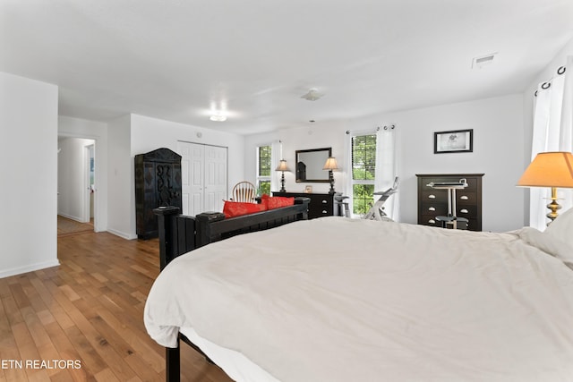 bedroom featuring wood finished floors and baseboards