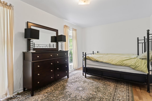 bedroom featuring wood finished floors