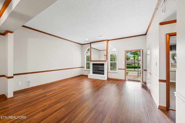 5039 Griffins Gate Ln, Knoxville, TN 37912 - unfurnished living room with crown molding, a healthy amount of sunlight, and wood-type flooring