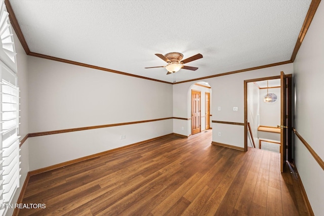 5039 Griffins Gate Ln, Knoxville, TN 37912 - empty room with a textured ceiling, baseboards, dark wood finished floors, ceiling fan, and arched walkways