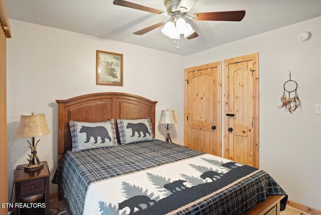 bedroom featuring baseboards and ceiling fan