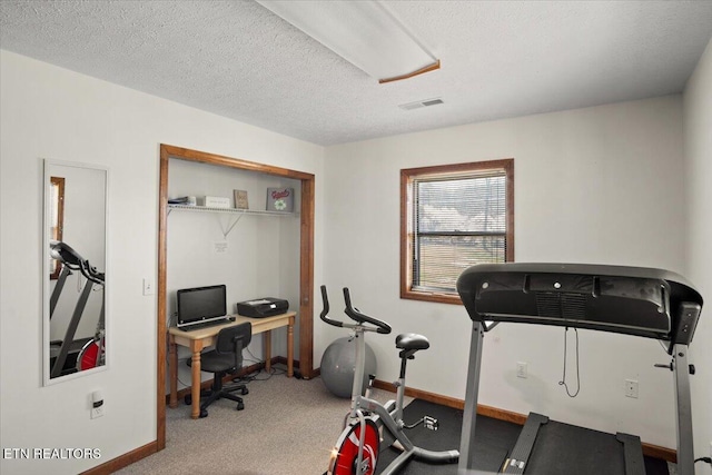 workout room with carpet and baseboards