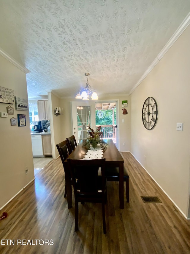 205 Browder Rd, Kingston, TN 37763 - dining space with a notable chandelier, a textured ceiling, ornamental molding, visible vents, and wood finished floors