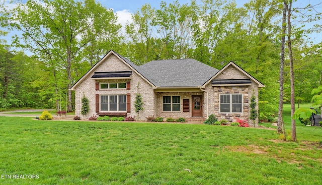 craftsman-style house featuring a front lawn and brick siding