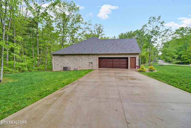 view of home's exterior with brick siding, a lawn, concrete driveway, an attached garage, and central air condition unit