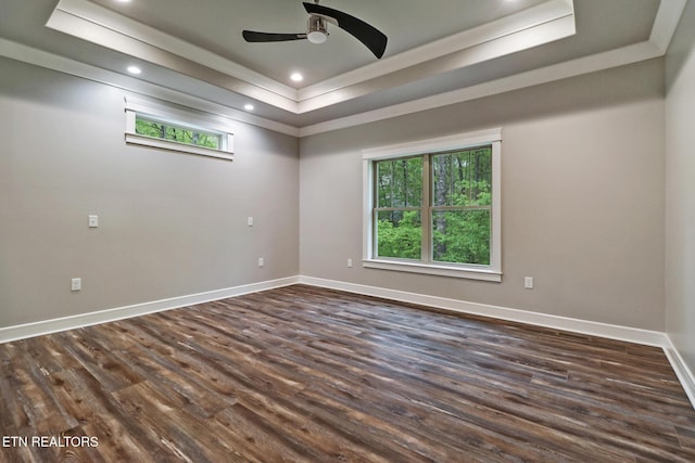 empty room with a tray ceiling, dark wood-style flooring, baseboards, ceiling fan, and recessed lighting