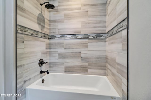 bathroom with washtub / shower combination