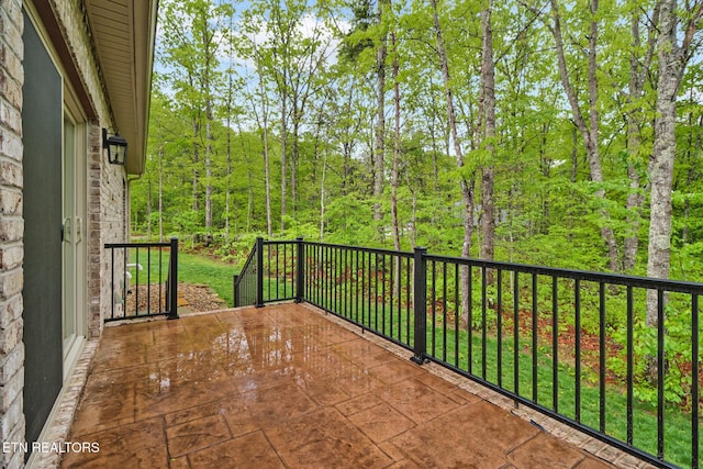 balcony featuring a view of trees