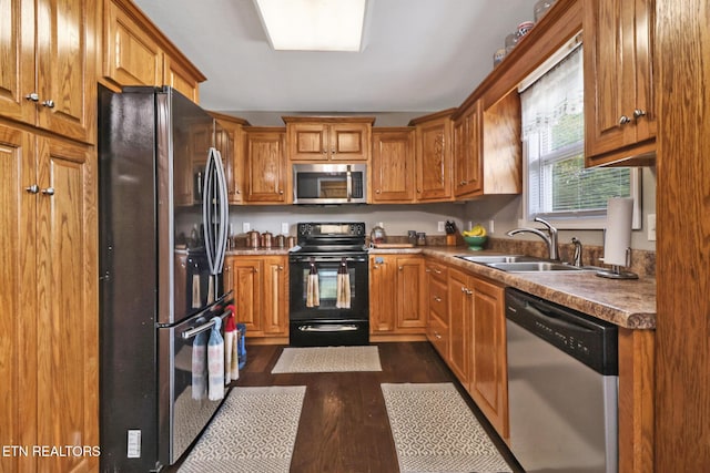 838 Buffalo Trl, Clarkrange, TN 38553 - kitchen featuring stainless steel appliances, a sink, dark wood-style flooring, and brown cabinetry