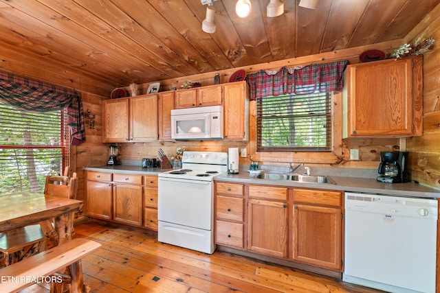 kitchen with white appliances, a sink, wood ceiling, light countertops, and light wood-style floors