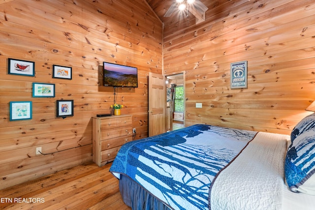 bedroom featuring wood walls and hardwood / wood-style floors