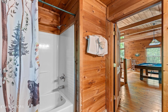 bathroom featuring wood walls, billiards, shower / bath combo with shower curtain, wood ceiling, and beam ceiling