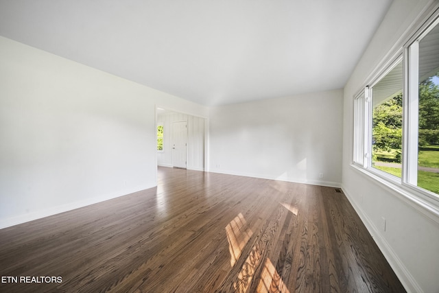 908 Glenoaks Dr, Knoxville, TN 37918 - unfurnished room featuring healthy amount of natural light, dark wood-type flooring, and baseboards