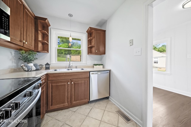 908 Glenoaks Dr, Knoxville, TN 37918 - kitchen featuring a sink, stainless steel appliances, open shelves, and healthy amount of natural light