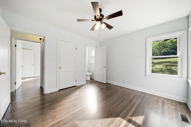908 Glenoaks Dr, Knoxville, TN 37918 - unfurnished bedroom with wood finished floors, baseboards, and ensuite bathroom