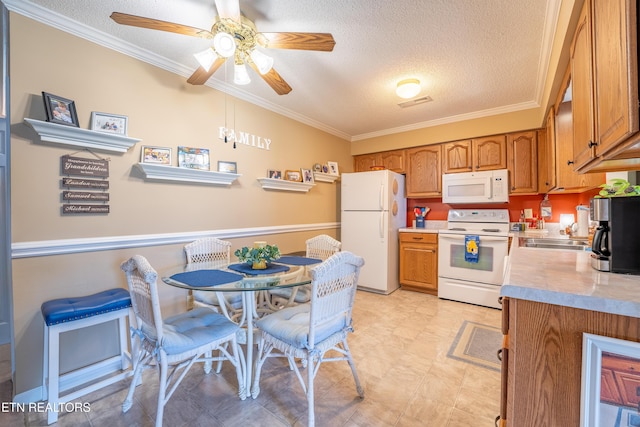 122 Hawthorne Oaks Way, Powell, TN 37849 - kitchen with white appliances, ornamental molding, light countertops, ceiling fan, and a textured ceiling