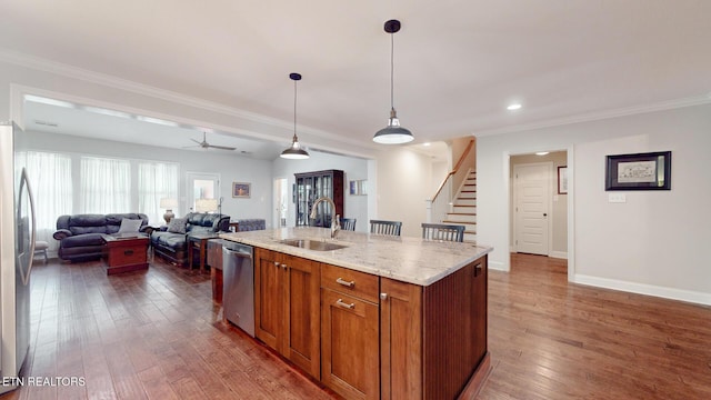 471 Roseland Ln, Lenoir City, TN 37772 - kitchen featuring a sink, appliances with stainless steel finishes, dark wood finished floors, brown cabinetry, and pendant lighting