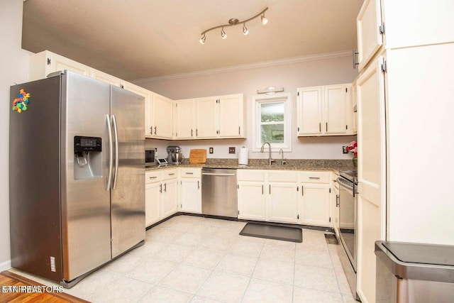 kitchen with appliances with stainless steel finishes, crown molding, a sink, stone countertops, and white cabinets
