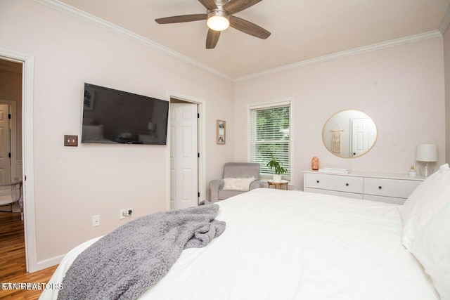 bedroom with ornamental molding, wood finished floors, a ceiling fan, and baseboards