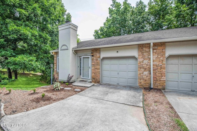 view of front of house featuring stone siding, a chimney, concrete driveway, roof with shingles, and stucco siding
