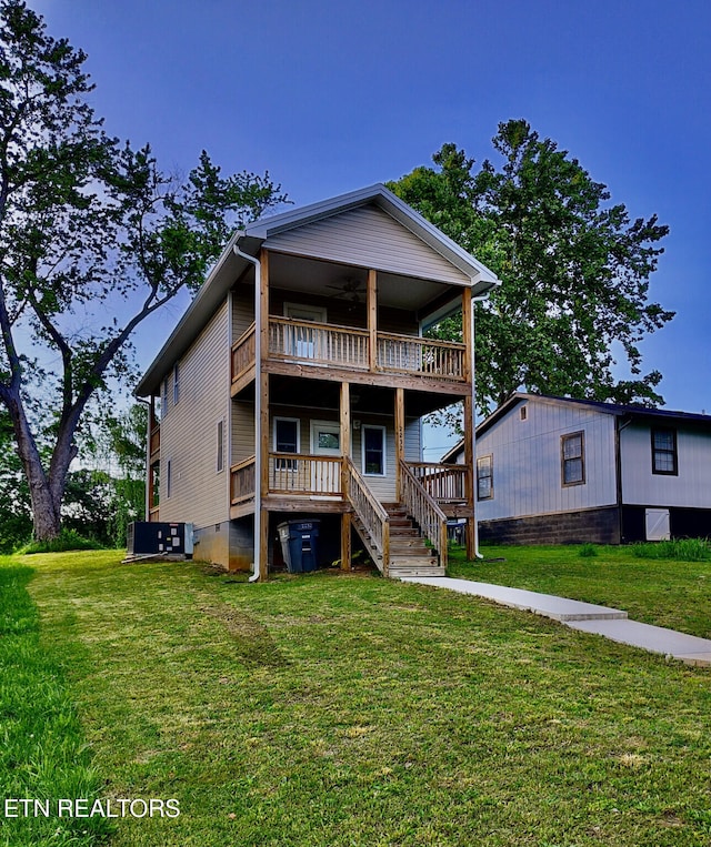 2232 Mississippi Ave, Knoxville, TN 37921 - rear view of house with a balcony, a lawn, ceiling fan, and stairway