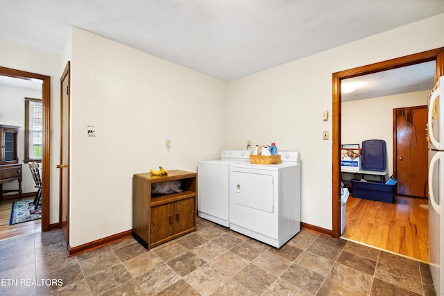3606 Sevier Heights Rd, Knoxville, TN 37920 - laundry area with independent washer and dryer, baseboards, and stone finish floors