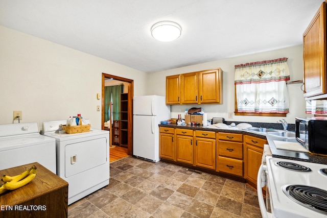 3606 Sevier Heights Rd, Knoxville, TN 37920 - kitchen with white appliances, washer and dryer, brown cabinets, dark countertops, and a sink
