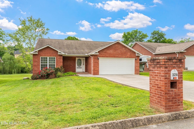 single story home featuring an attached garage, a front lawn, brick siding, and driveway