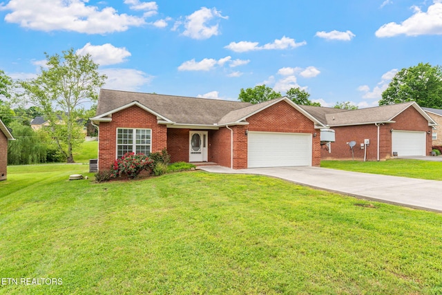single story home with a garage, brick siding, a front yard, and driveway