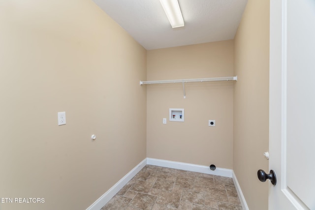 washroom featuring washer hookup, hookup for an electric dryer, baseboards, and stone finish flooring