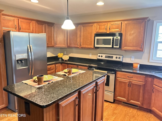 326 Joshua Landing Ct, Seymour, TN 37865 - kitchen featuring stainless steel appliances, light wood-type flooring, brown cabinetry, recessed lighting, and decorative light fixtures