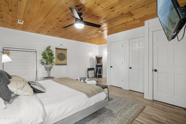 bedroom with wood ceiling, wood finished floors, and a ceiling fan