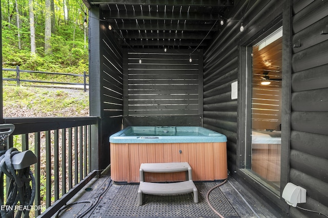wooden deck featuring a hot tub