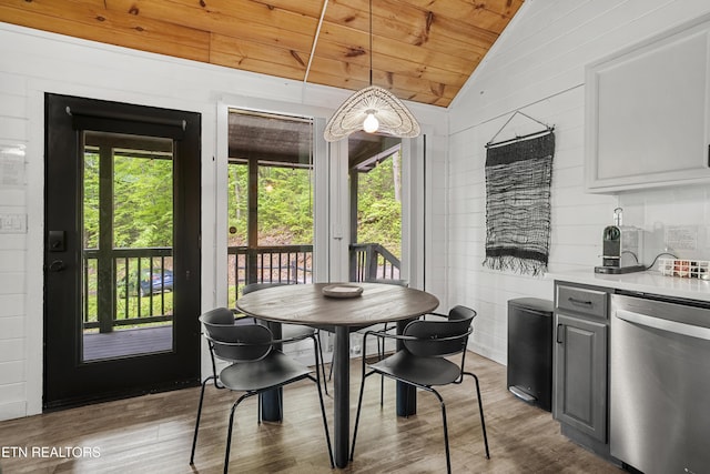 dining area with lofted ceiling, wood ceiling, and wood finished floors
