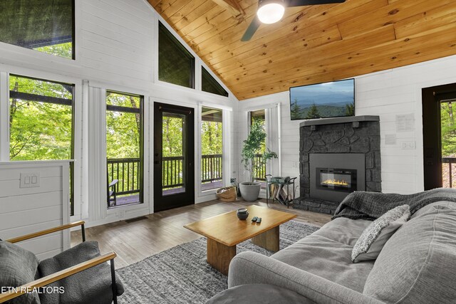 sunroom featuring vaulted ceiling and plenty of natural light
