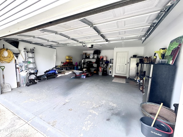 208 Cornerstone Cir, Clinton, TN 37716 - garage featuring a garage door opener and freestanding refrigerator