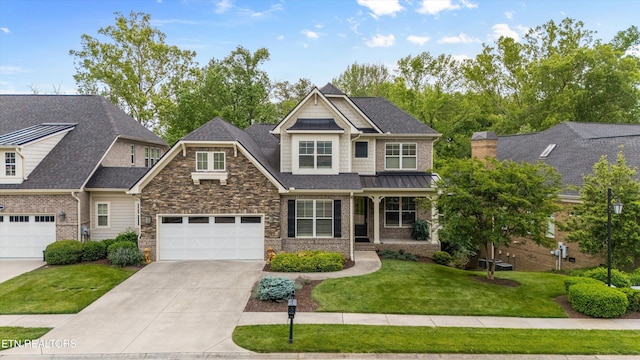 462 Chapel Grove Ln, Knoxville, TN 37934 - craftsman house featuring concrete driveway, a front yard, an attached garage, brick siding, and covered porch